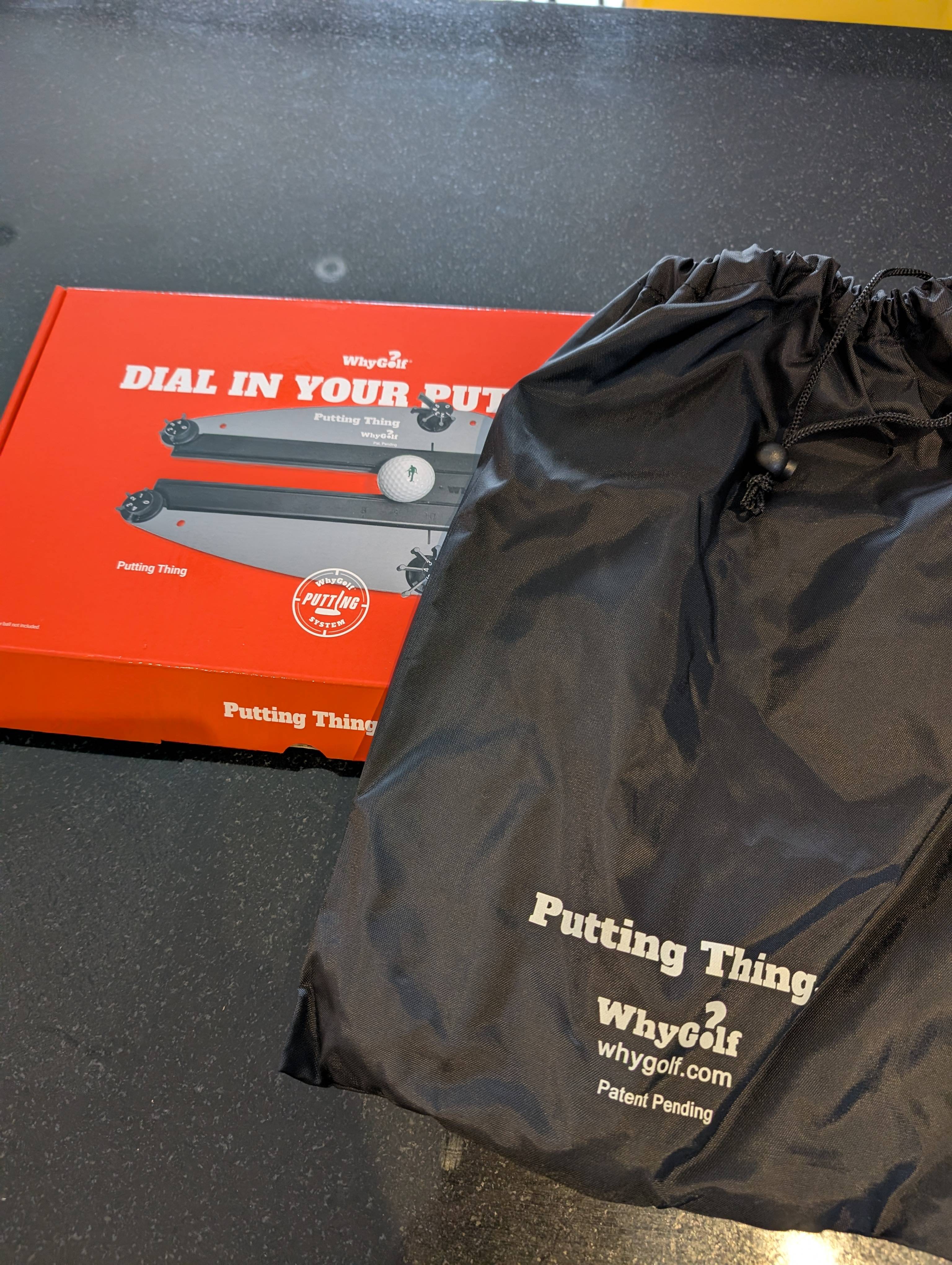 The Putting Thing carry bag and product box.